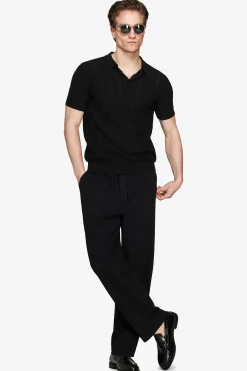Polo in maglia traforata nera