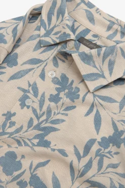Polo in piquet fantasia fiore celeste